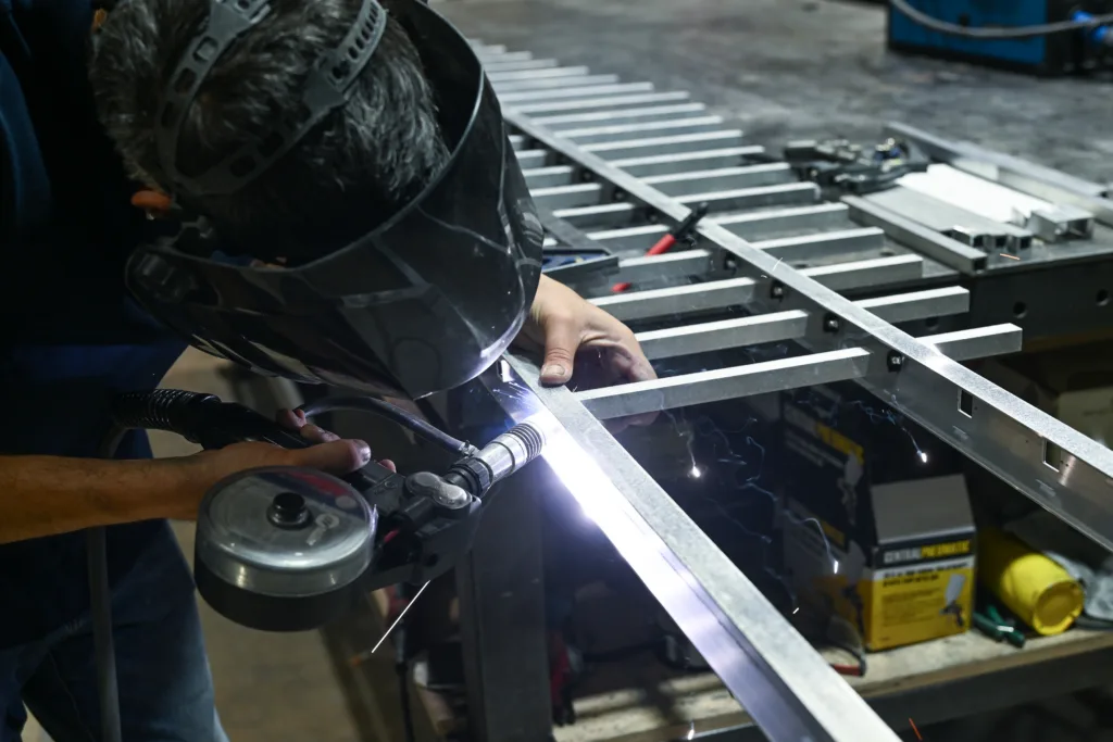 Thor Metal Art welder crafting a custom metal gate in Miami workshop
