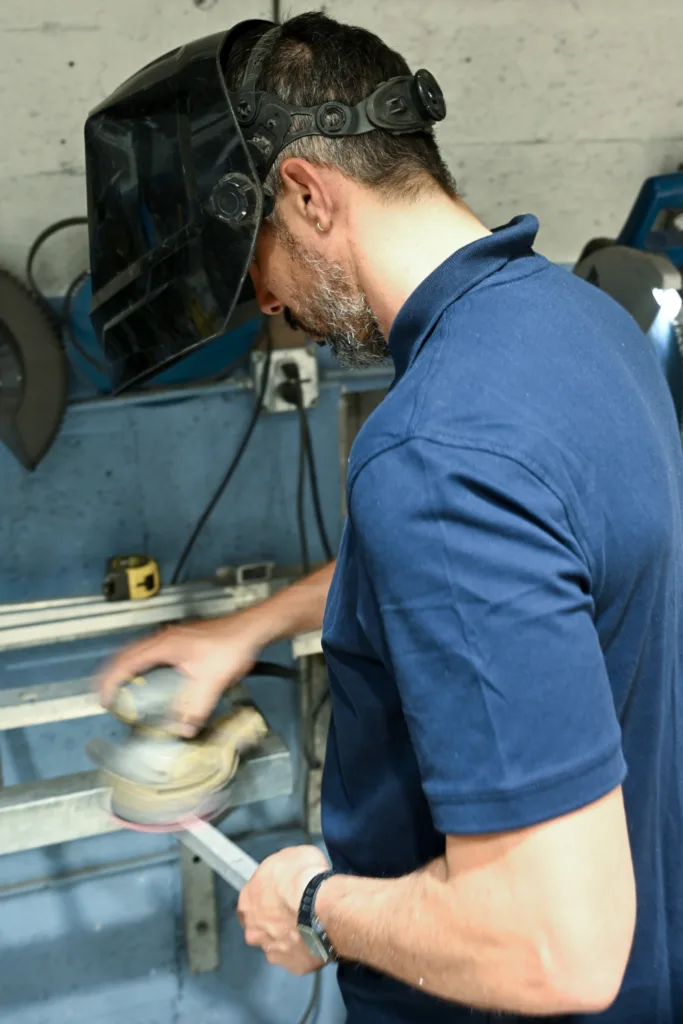 Polishing and finishing a metal railing at Thor Metal Art